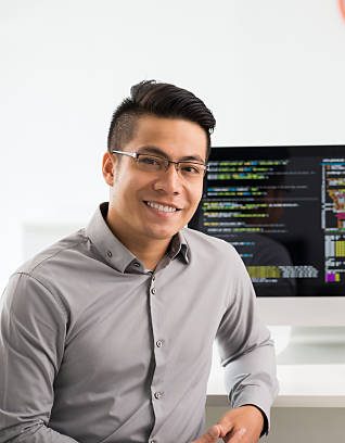 Portrait of smiling young Vietnamese software engineer